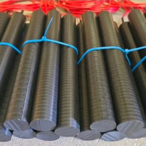 German text advertising resistant plastic grounding electrode; photo shows bundles of black ribbed grounding rods tied with blue ties laid in a row, likely for electrical grounding.